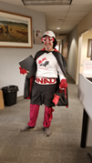 A man is dressed in a superhero costume with a Maple Leaf on the front.
