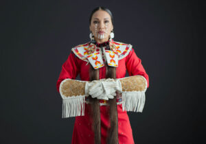 Indigenous woman in red regalia